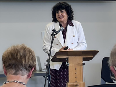 Minister for Seniors Hon Casey Costello standing at podium 