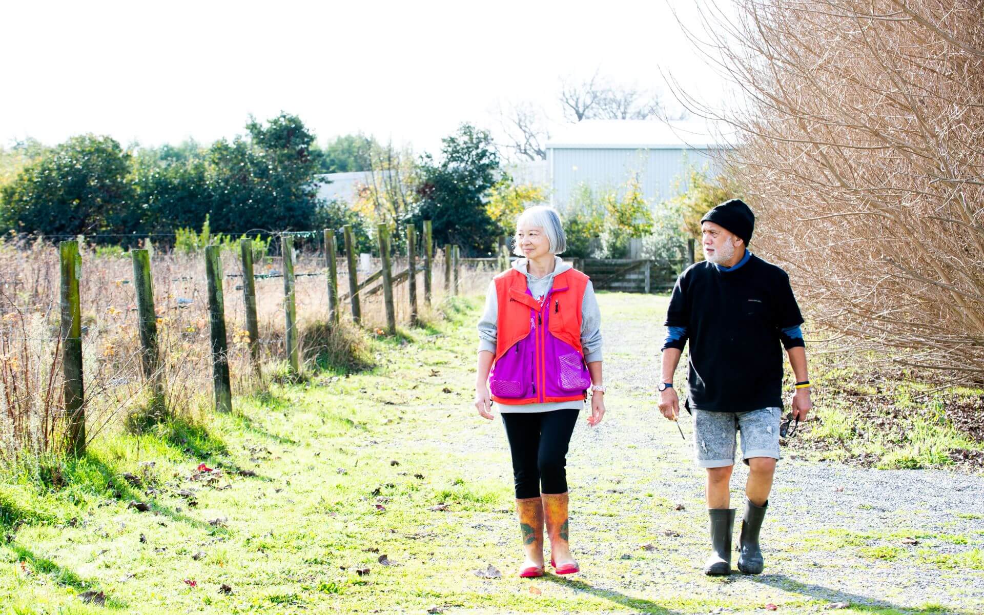 Two older people walking outside